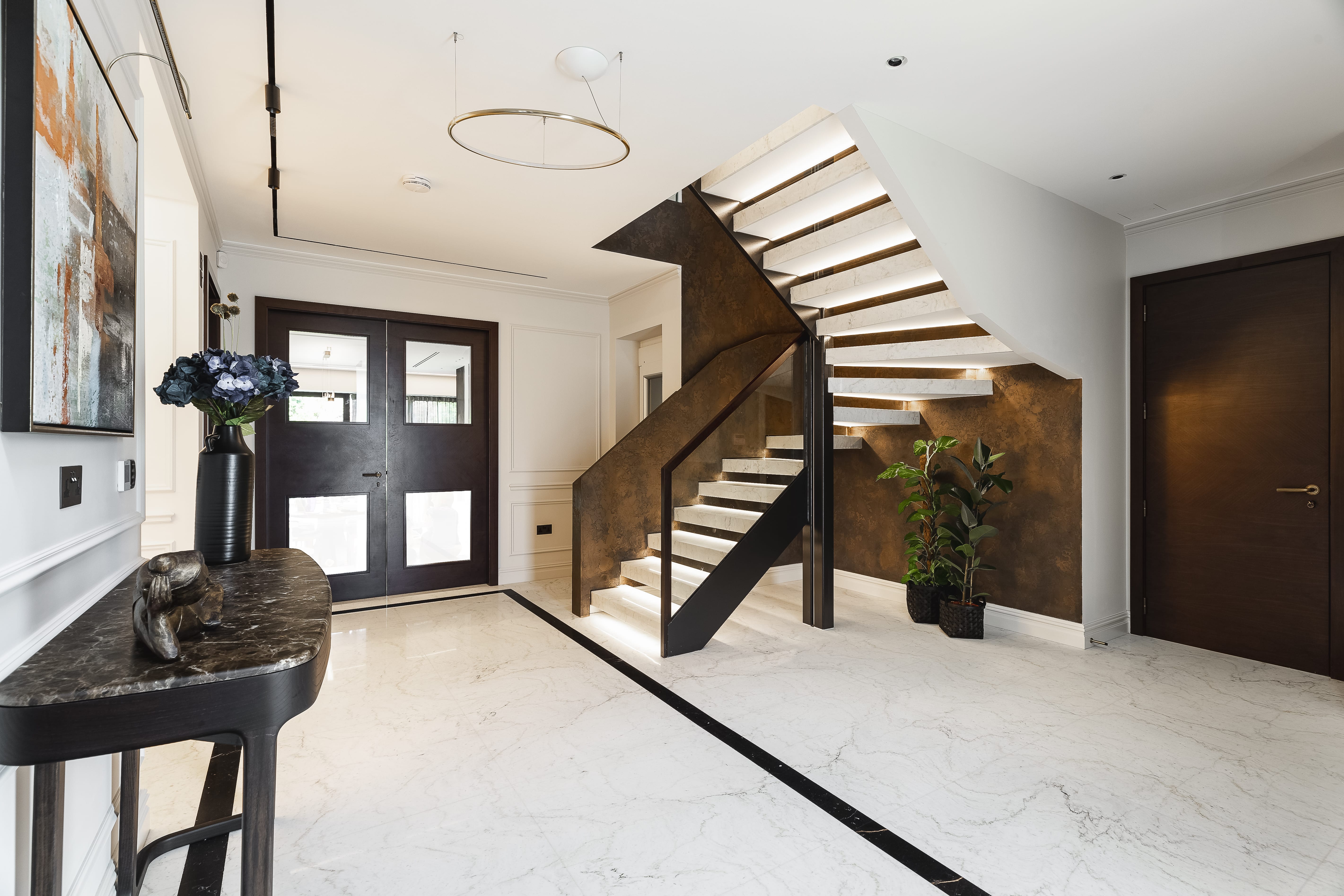 The hallway of a house that has just undergone a remodelling to the staircase with an extension upstairs